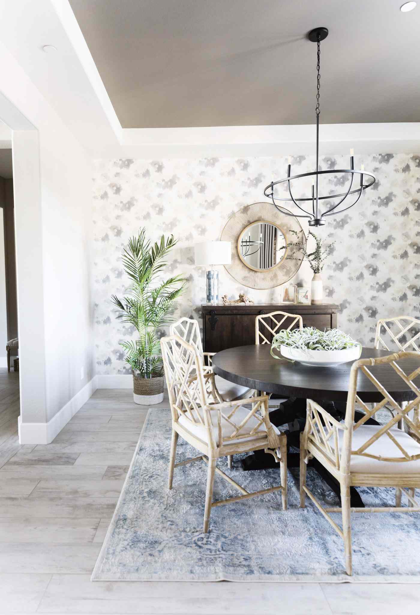 Wallpapered dining room with a patterned accent wall